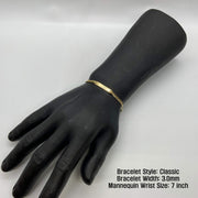 Black mannequin wrist display wearing a 3.0mm 14k gold Classic style ID bracelet.