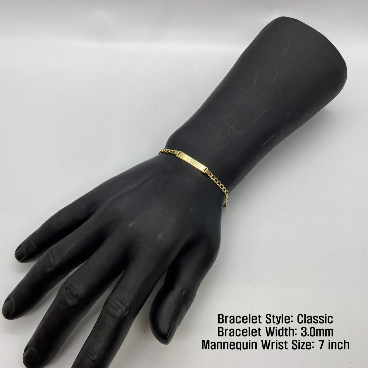 Black mannequin wrist display wearing a 3.0mm 14k gold Classic style ID bracelet.