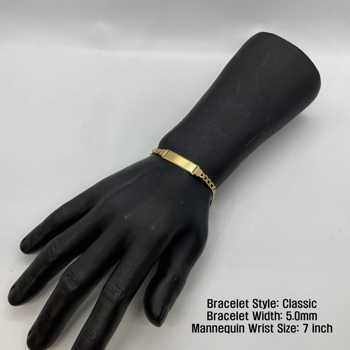 Black mannequin wrist display wearing a 5.0mm 14k gold Classic style ID bracelet.