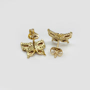 Rear view of gold butterfly stud earrings with push-back closures on white background.