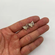 14k gold Elan butterfly stud earrings hand size perspective jewelry scale.