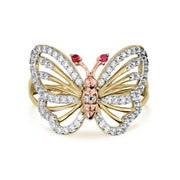 Profile view of a two-tone gold butterfly ring showcasing the raised crystal setting