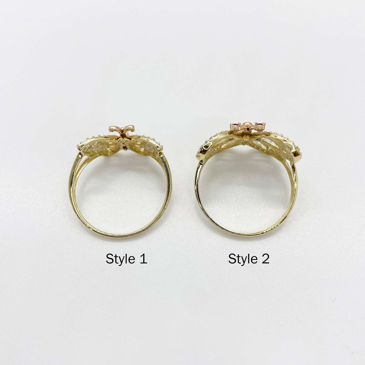 two 14k gold rings with butterfly design top view labeled Style 1 and Style 2 on a white background