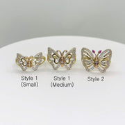 Three 14k gold butterfly shaped rings labeled with size and style on a white surface.
