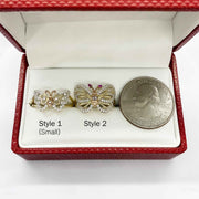 Two 14k gold butterfly shaped earrings in a red box with a quarter for scale.