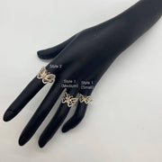 Black mannequin hand wearing a three 14k gold butterfly style rings with size labels on a white background