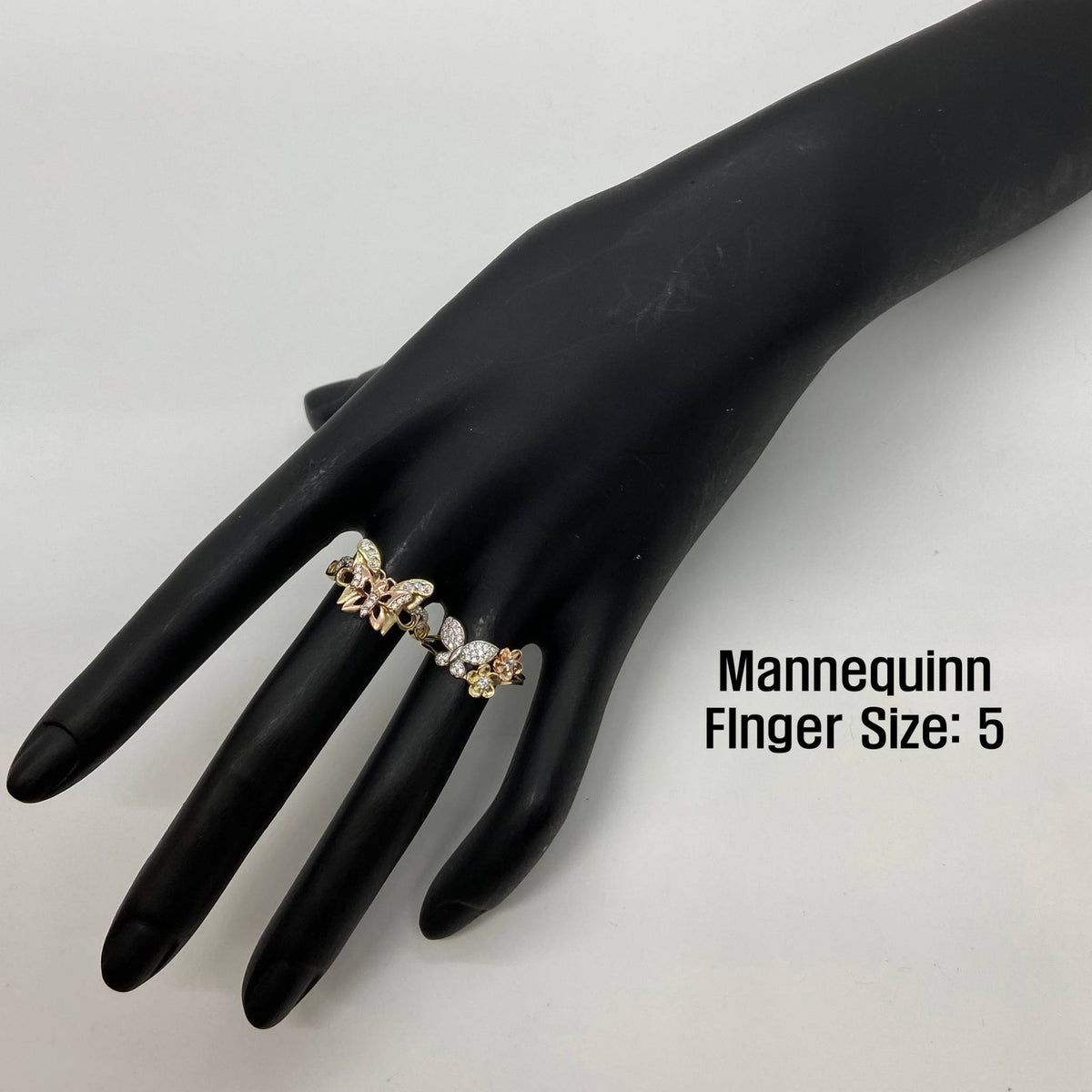 two 14k Gold Helic Butterfly ring on a black mannequin hand.