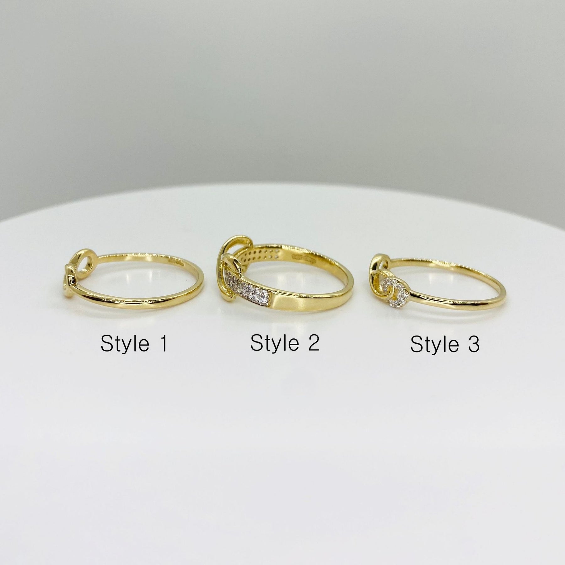 Three 14k gold infinity rings sideview labeled Style 1, Style 2, and Style 3 