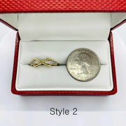 14k Gold  Infinity shaped ring in a red jewelry box with a quarter for scale 