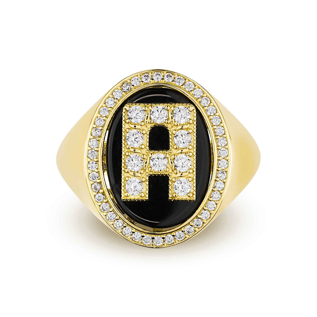 Top-down view of an oval yellow gold ring with a crystal-paved letter "A" on black onyx.