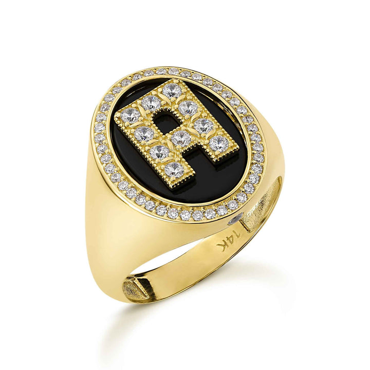 Yellow gold and black onyx initial signet ring with cubic zirconia accents.