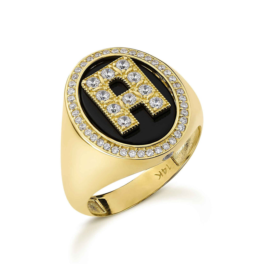 Yellow gold and black onyx initial signet ring with cubic zirconia accents.