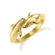 Angled view of 14k gold Kari dual dolphin ring on a white background.