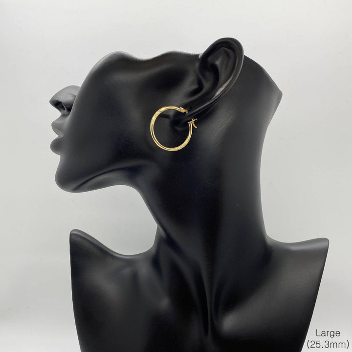 Large 25.3mm 14k gold hoop earring featuring a 2mm tube and matte finish.