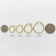 Scale reference for 14k gold matte round hoop earrings ranging from 15.2mm to 25.3mm.