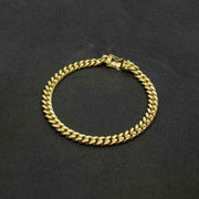 Polished 14k gold hollow Miami Cuban chain bracelet with box lock clasp on black background.
