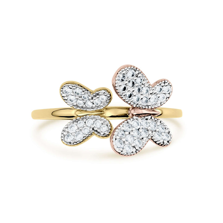 Two-tone gold butterfly ring with shimmering clear gemstones on a white background.