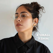 Model wearing X Small 7.5mm 14k gold Guadalupe heart stud earrings.