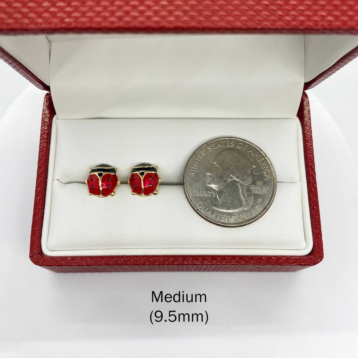 14k gold Medium 9.5mm ladybug stud earrings shown next to a US quarter for size reference.