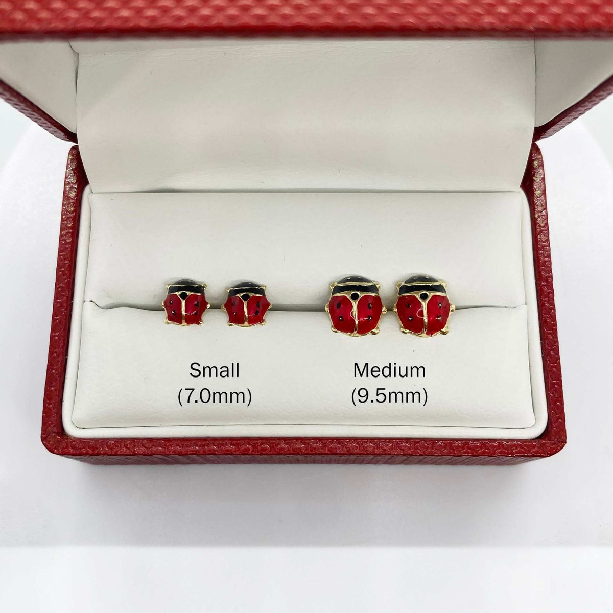 14k gold ladybug stud earrings size comparison: Small 7.0mm and Medium 9.5mm side-by-side.