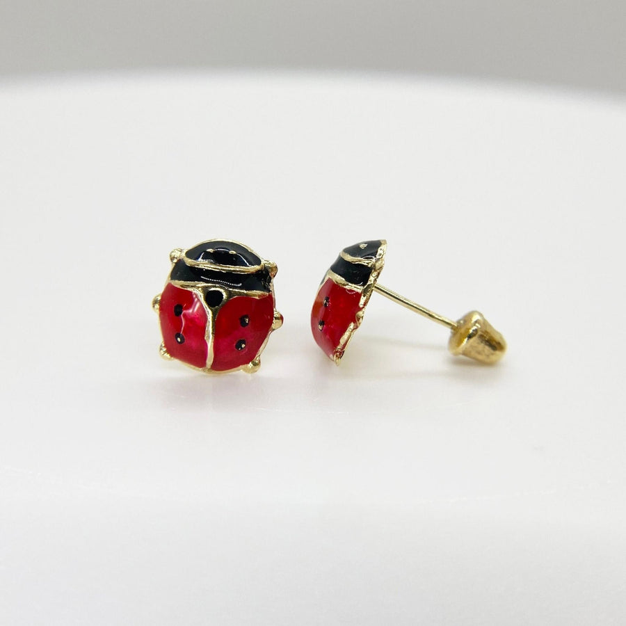 14k gold ladybug stud earrings with red and black enamel and secure screw backs.