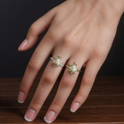 Two polished multi-toned gold turtle rings stacked beautifully on a manicured hand.
