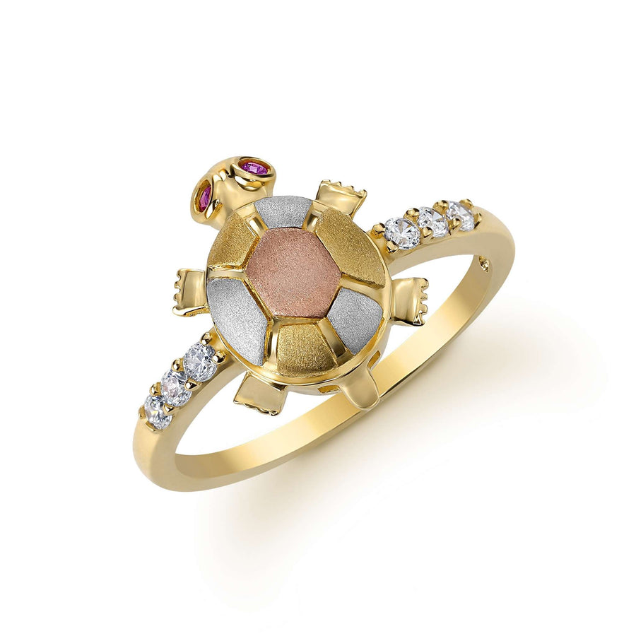 Angled view of a 14k gold tri-color turtle ring set with cubic zirconia