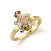14k gold turtle ring with tri-color shell and pink stone eyes on white background.