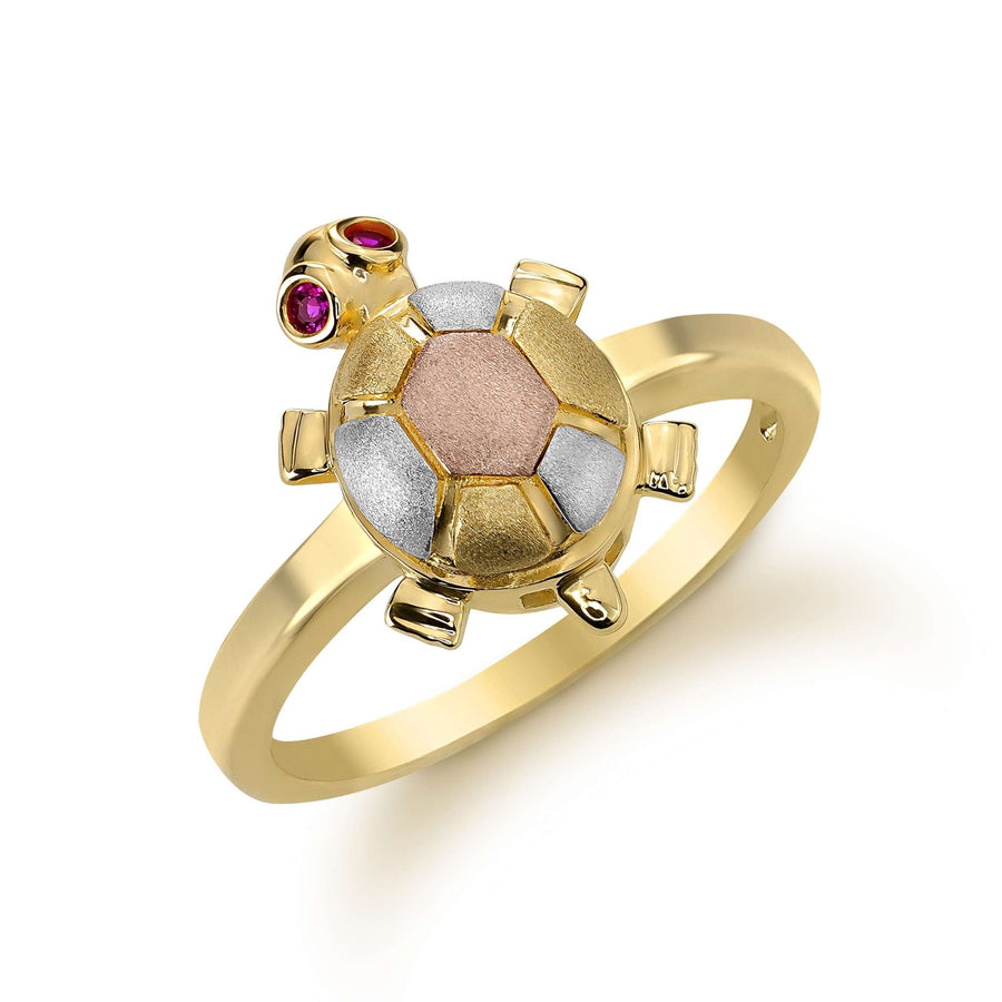 14k gold turtle ring with tri-color shell and pink stone eyes on white background.