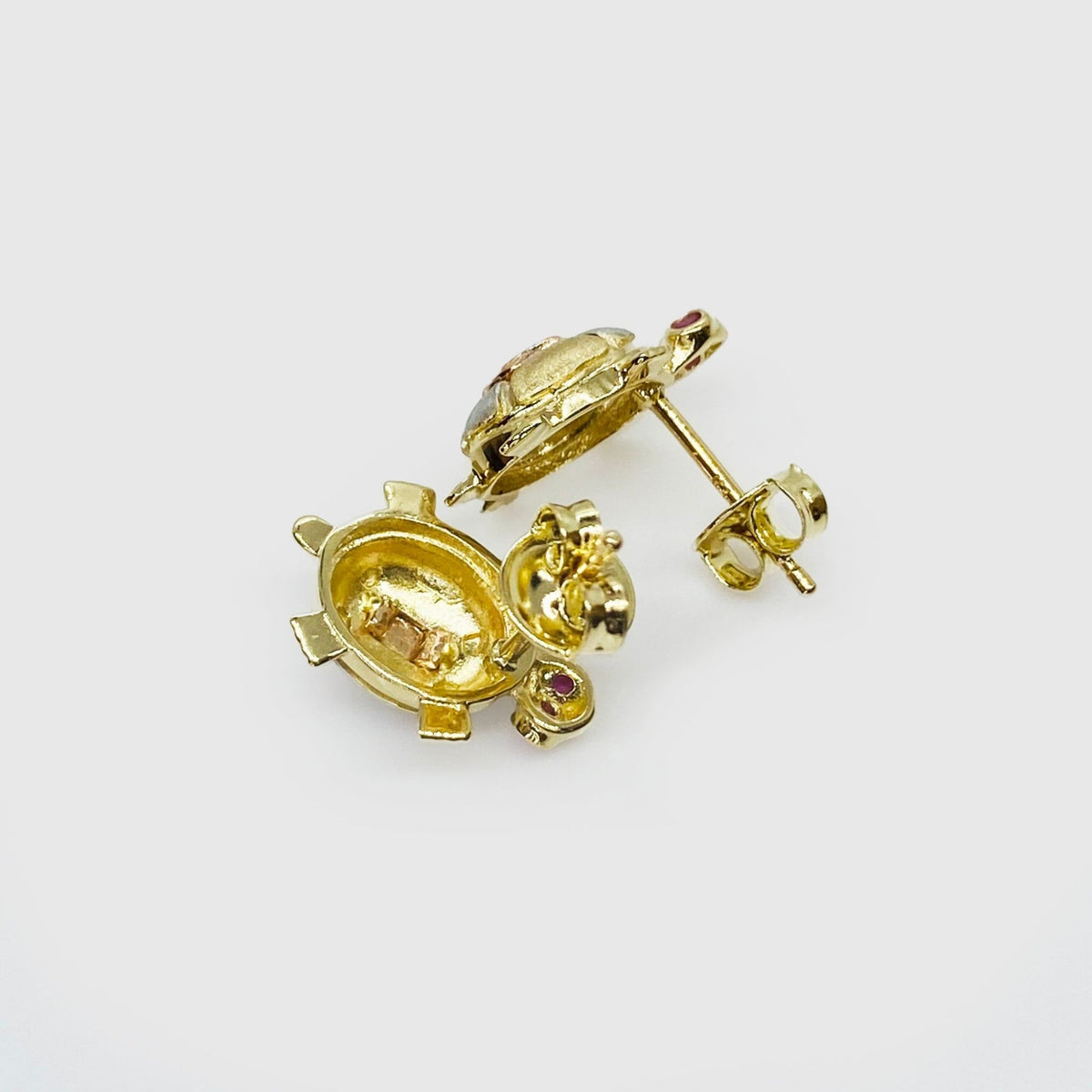 Rear view of 14k gold tri-color turtle stud earrings showcasing secure push-back backings.