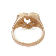 Inside view of a gold heart ring showcasing the reverse side of 'MOM'