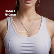 A model wearing the small tri-color gold Guadalupe pendant highlighting the 19.0mm size.