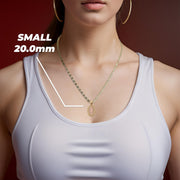 A model wearing the small two-tone gold Guadalupe pendant highlighting the 20.0mm size.