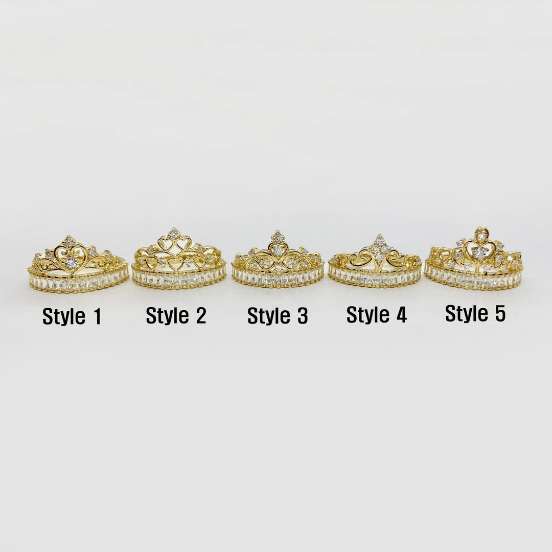 Five 14k gold tiara style rings with varying designs on a white background