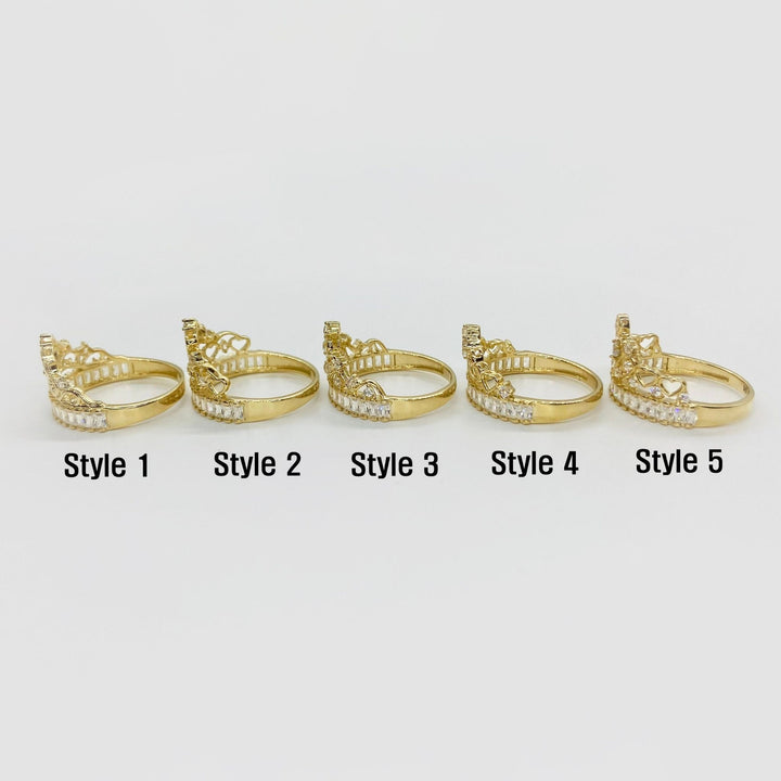 Five 14k gold rings with different crown designs side view on a white background