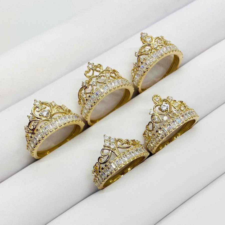 Set of 14k gold rings with Crown design with Cubic Zirconia on a white surface