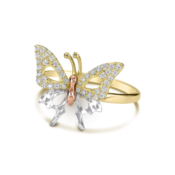 Side angle of a tricolor gold butterfly ring accented with cubic zirconia on white background.