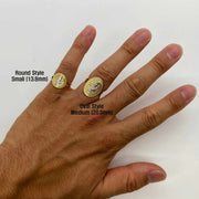 Hand wearing two 14k gold Saint Benedict rings with size labels on a white background