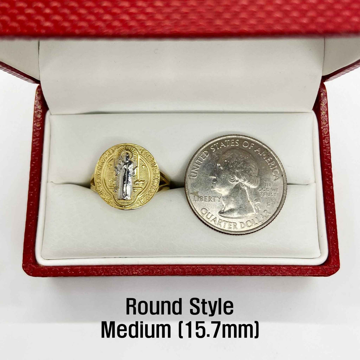 Round style saint benedict medium ring next to a quarter in a red box