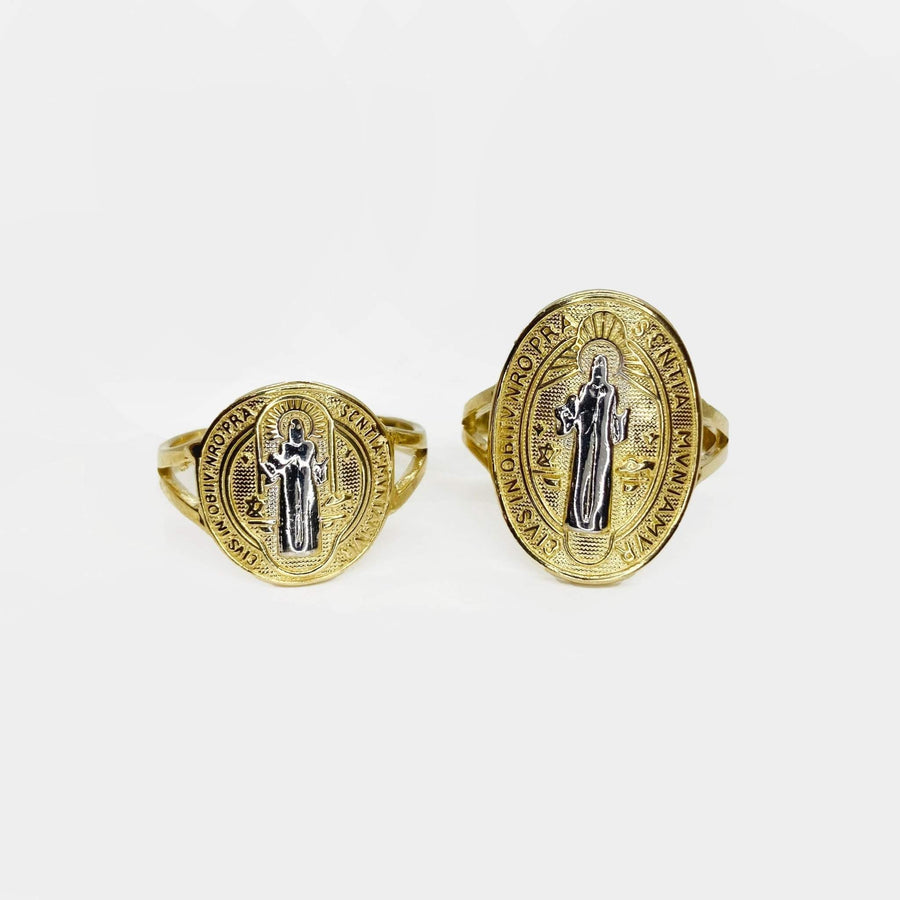 Two 14k gold rings with Saint Benedict designs on a white background