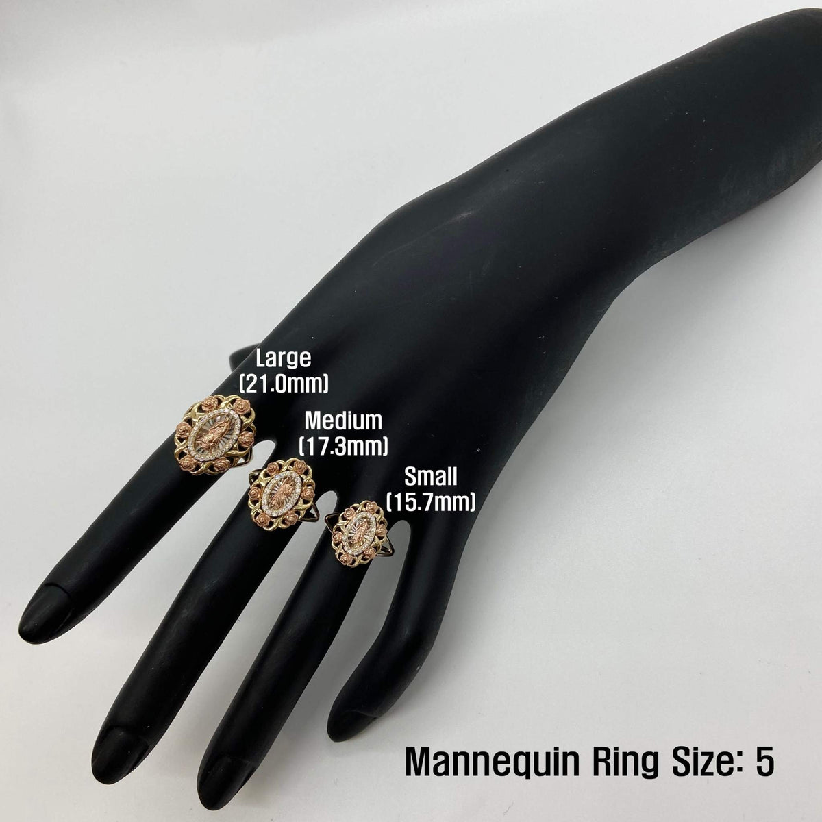 Three 14k gold rings on a black mannequin hand with size labels, against a white background.