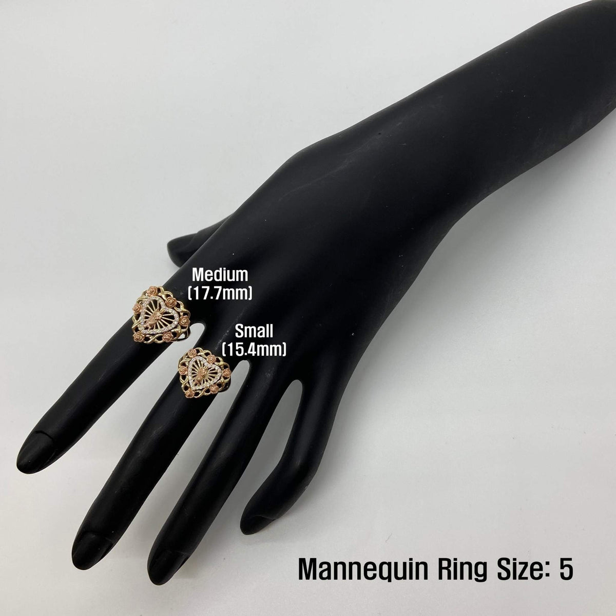 Two 14k gold heart rings on a black mannequin hand with size labels, against a white background