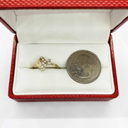 14k Gold ring with fish shape design in a red box next to a quarter for size comparison.