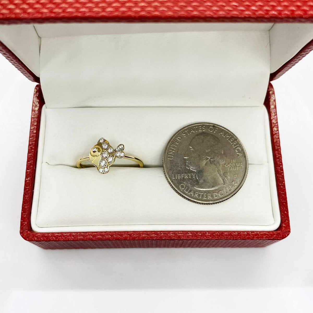 14k Gold ring with fish shape design in a red box next to a quarter for size comparison.