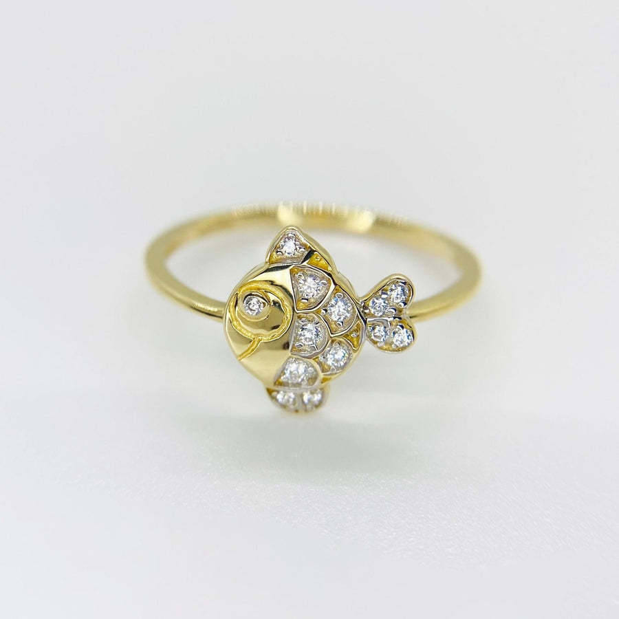 14k Gold ring with fish and sparkling cubic zirconia design on a light gray background