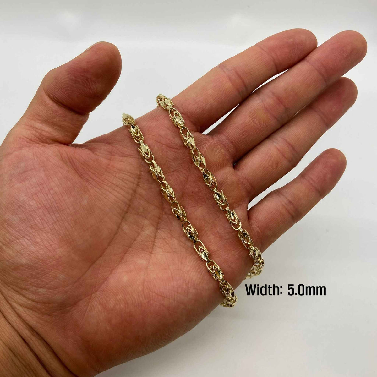 Hand holding a 5.0mm 14k gold vintage Turkish link chain for size reference.