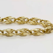 Detailed close-up showing the intricate woven link design of a 14k gold Turkish chain.