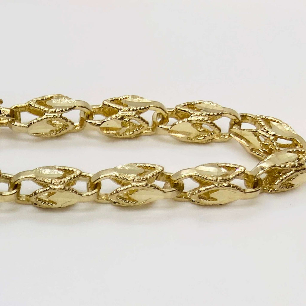 Detailed close-up showing the intricate woven link design of a 14k gold Turkish chain.