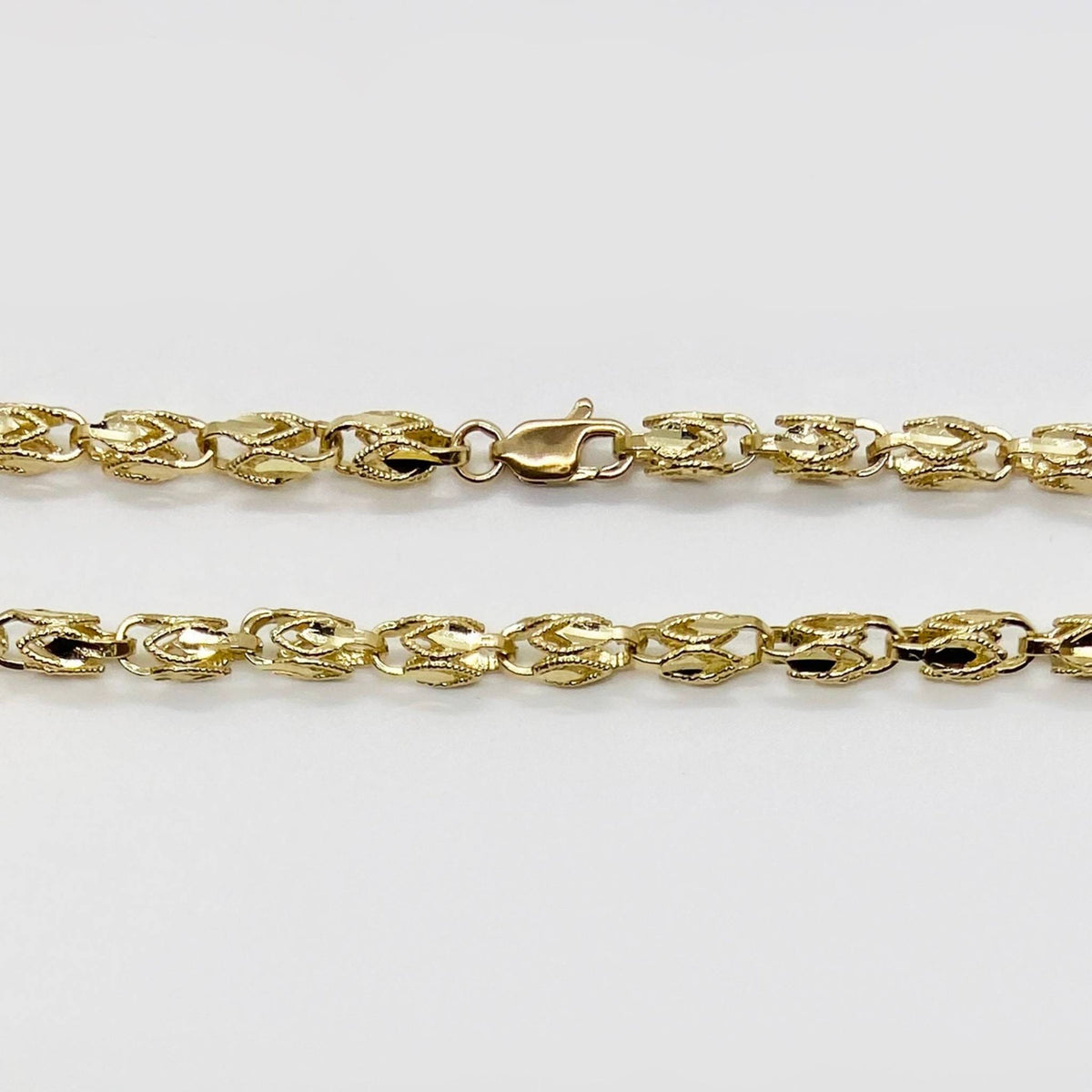 Close-up of a 14k gold vintage Turkish link chain showing the lobster clasp.