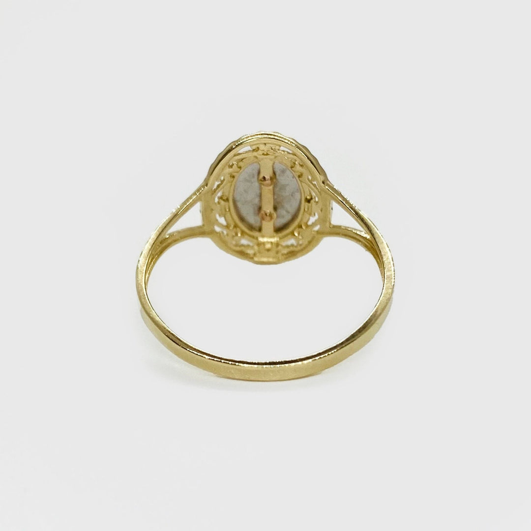 14k Gold ring with a oval shape design back view on a white background.